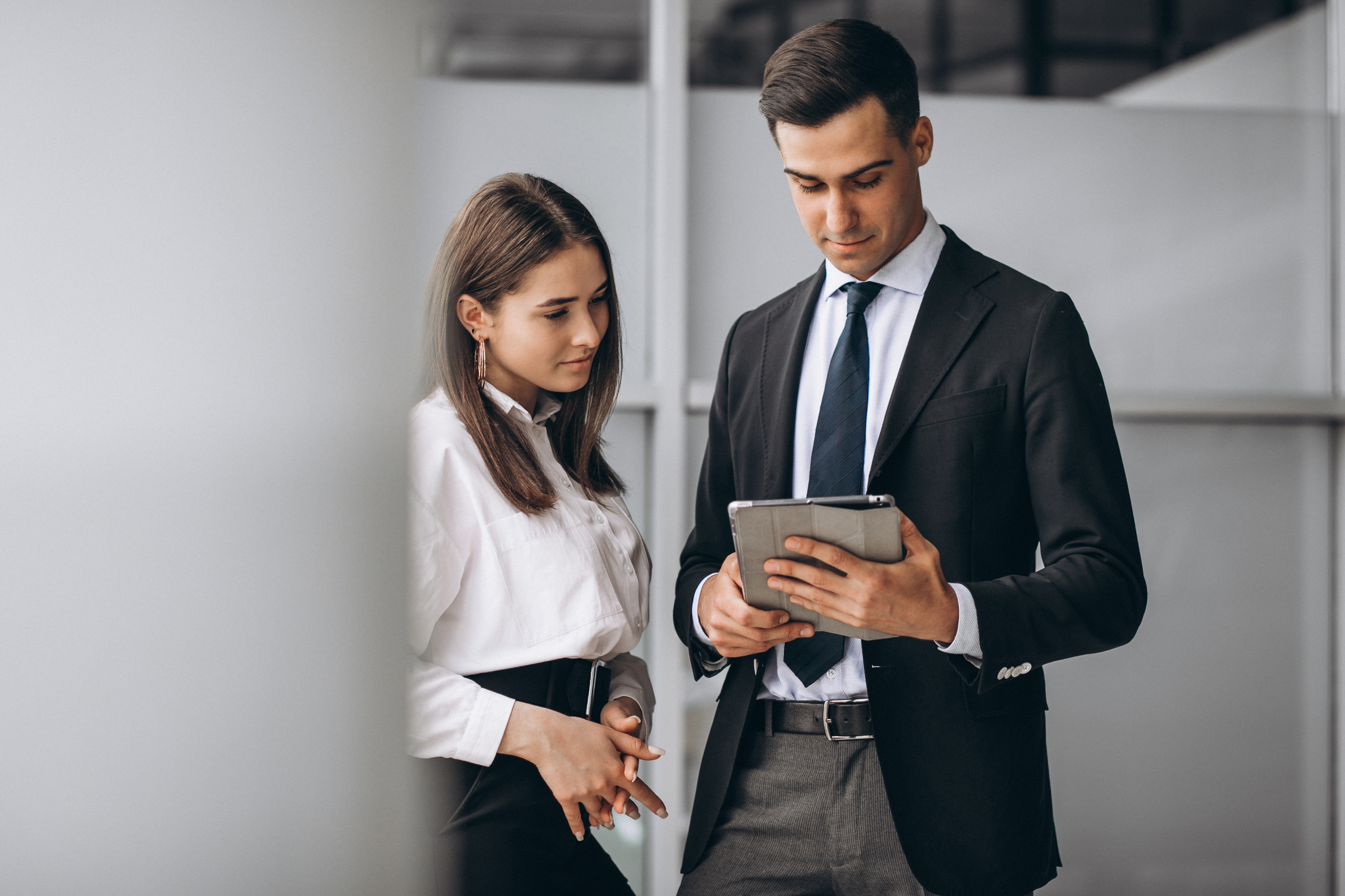Two professionals discussing on a tablet